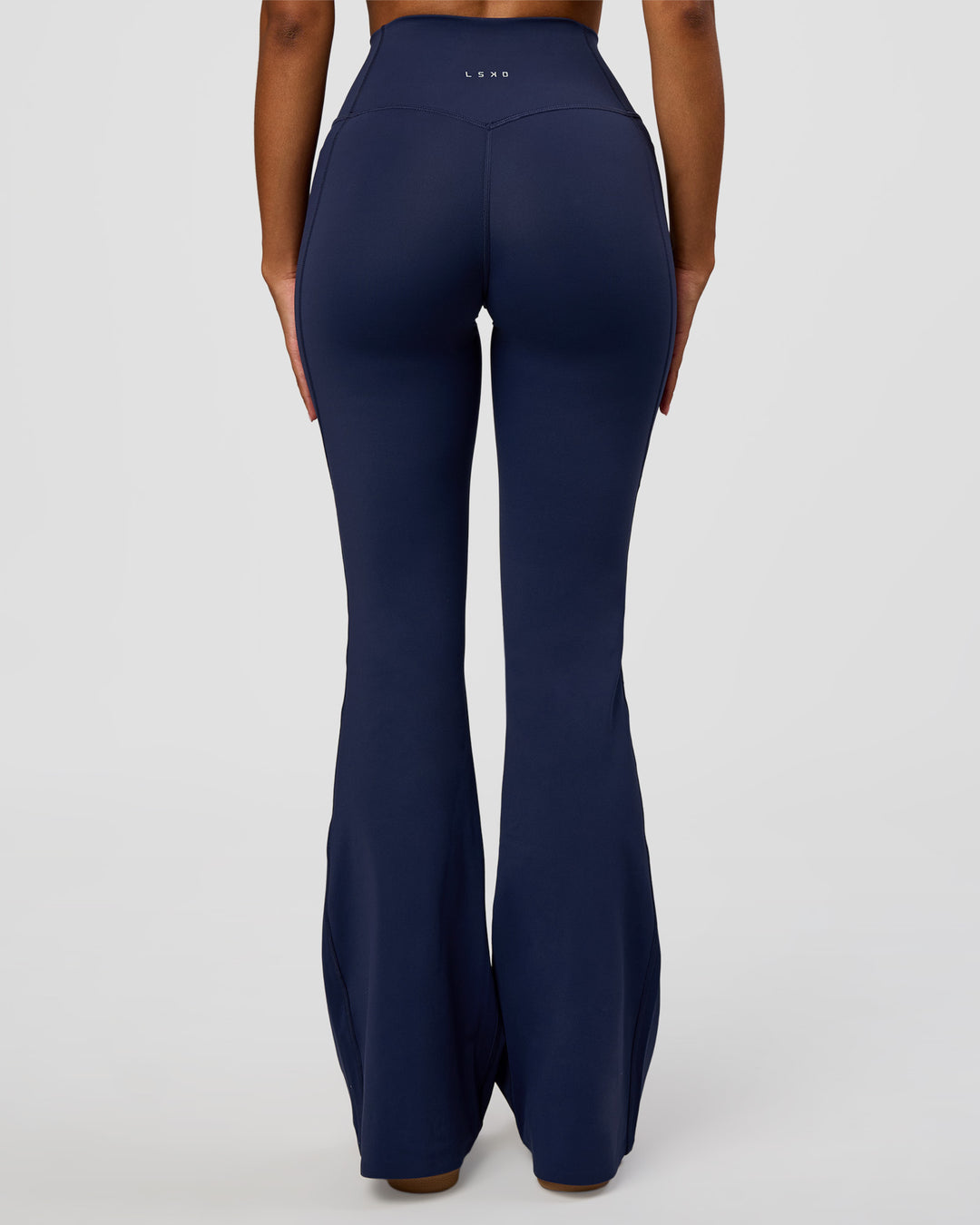 Woman wearing Fusion V-Contour High-Rise Flared Legging Pockets - Future Navy | Model:Jordan | Size:S
