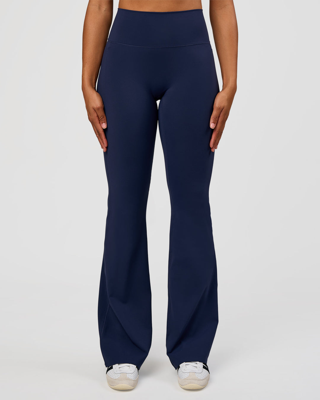 Woman wearing Fusion V-Contour High-Rise Flared Tall Legging Pockets - Future Navy | Model:Rosie | Size:S