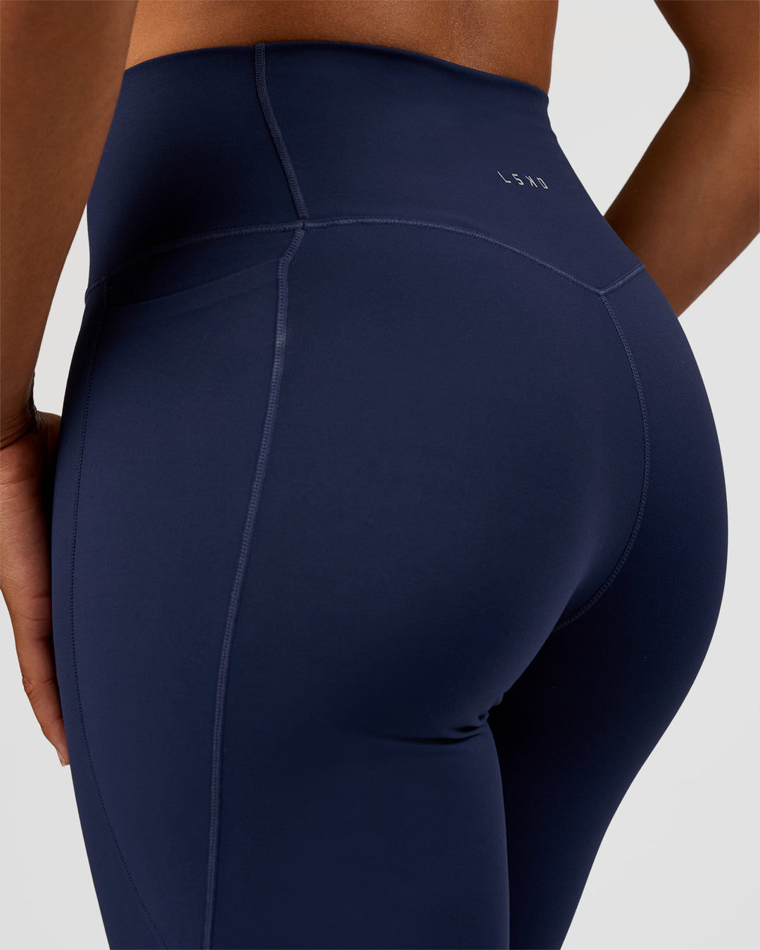 Woman wearing Fusion V-Contour High-Rise Flared Tall Legging Pockets - Future Navy | Model:Rosie | Size:S