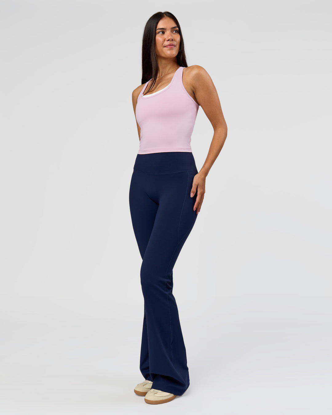 Woman wearing Fusion V-Contour High-Rise Flared Tall Legging Pockets - Future Navy | Model:Rosie | Size:S