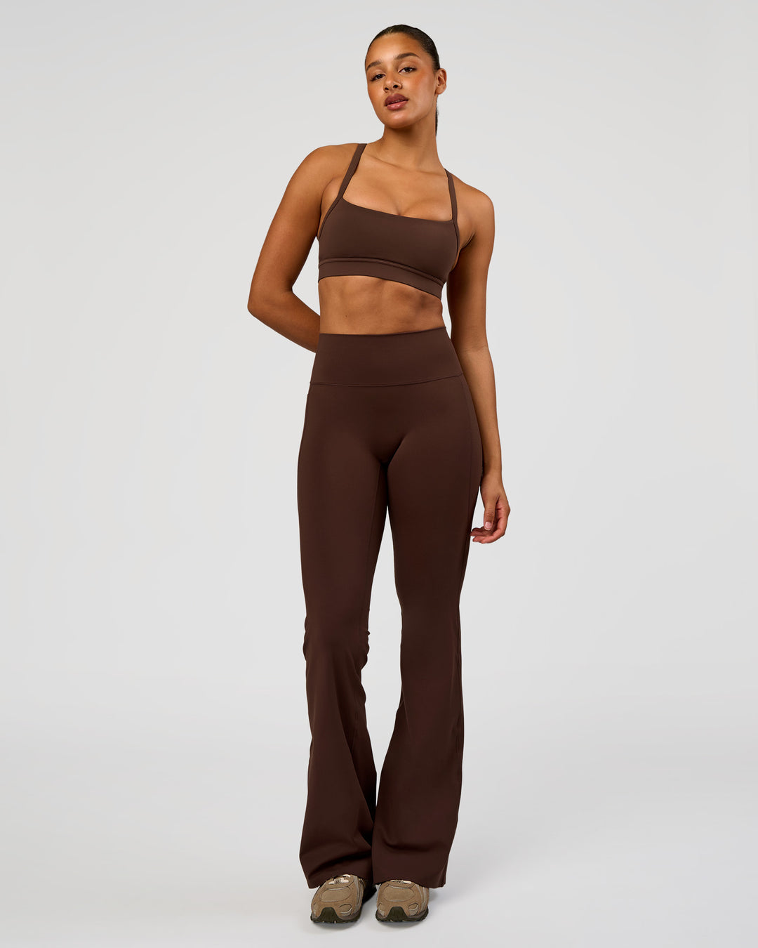 Woman wearing Fusion V-Contour High-Rise Flared Tall Legging Pockets - Hot Chocolate | Model:Rosie | Size:S