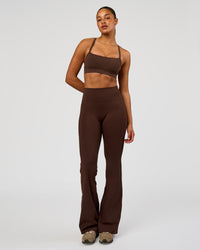 Woman wearing Fusion V-Contour High-Rise Flared Tall Legging Pockets - Hot Chocolate | Model:Rosie | Size:S