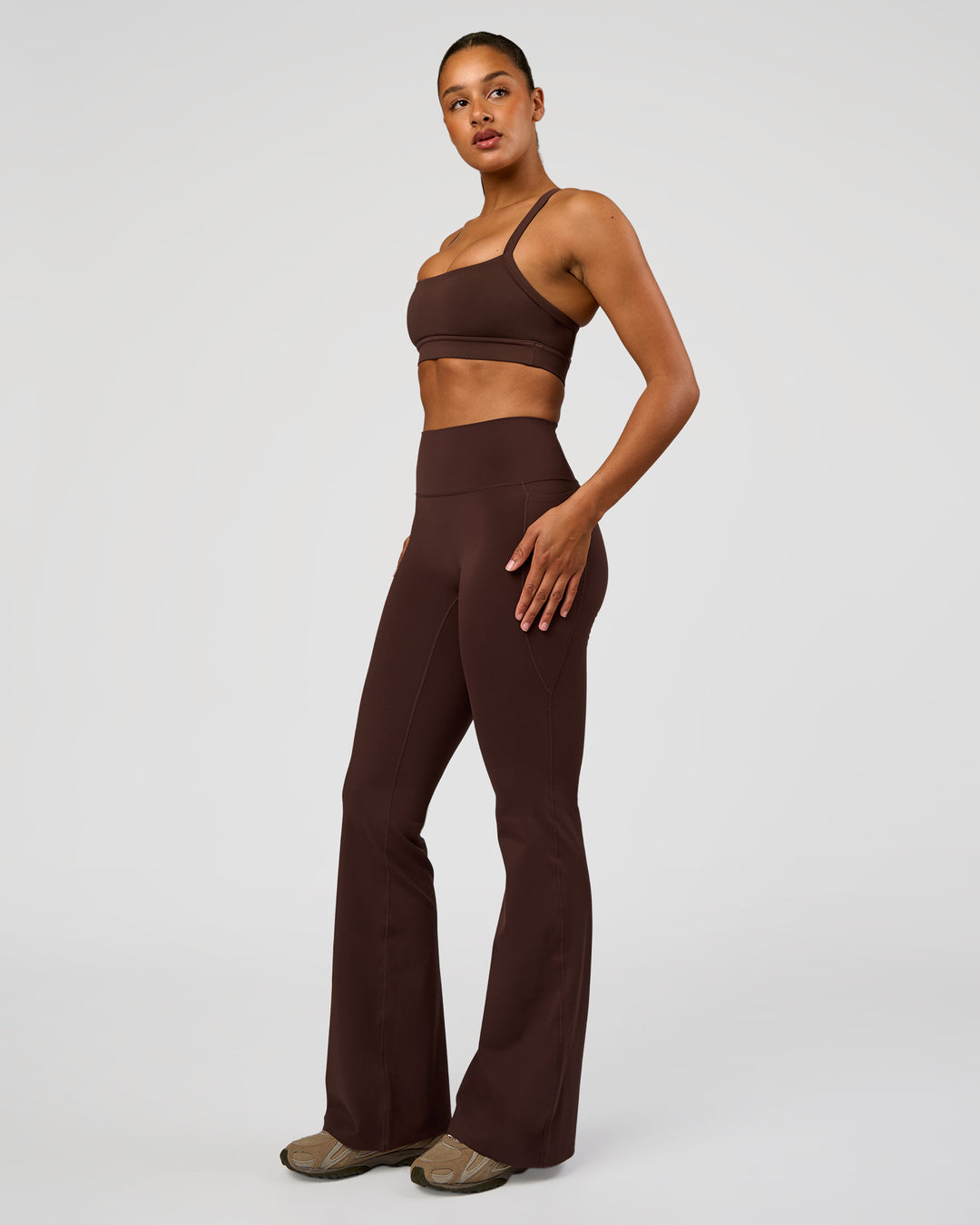 Woman wearing Fusion V-Contour High-Rise Flared Tall Legging Pockets - Hot Chocolate | Model:Rosie | Size:S