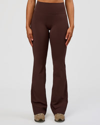 Woman wearing Fusion V-Contour High-Rise Flared Tall Legging Pockets - Hot Chocolate | Model:Rosie | Size:S