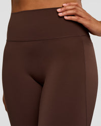 Woman wearing Fusion V-Contour High-Rise Flared Tall Legging Pockets - Hot Chocolate | Model:Rosie | Size:S