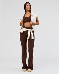 Woman wearing Fusion V-Contour High-Rise Flared Tall Legging Pockets - Hot Chocolate | Model:Rhiley | Size:S
