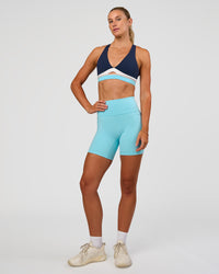 Woman wearing Fusion V-Contour Ultra High-Rise 6" Short Pockets - Baltic Sea | Model:Emelia | Size:S