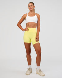 Woman wearing Fusion V-Contour Ultra High-Rise 6" Short Pockets - Yellow Fizz | Model:Emelia | Size:S