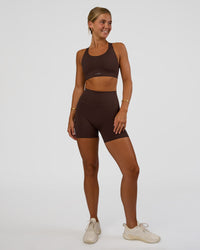 Woman wearing Fusion V-Contour Ultra High-Rise 4” Short Pockets - Hot Chocolate | Model:Amity | Size:S