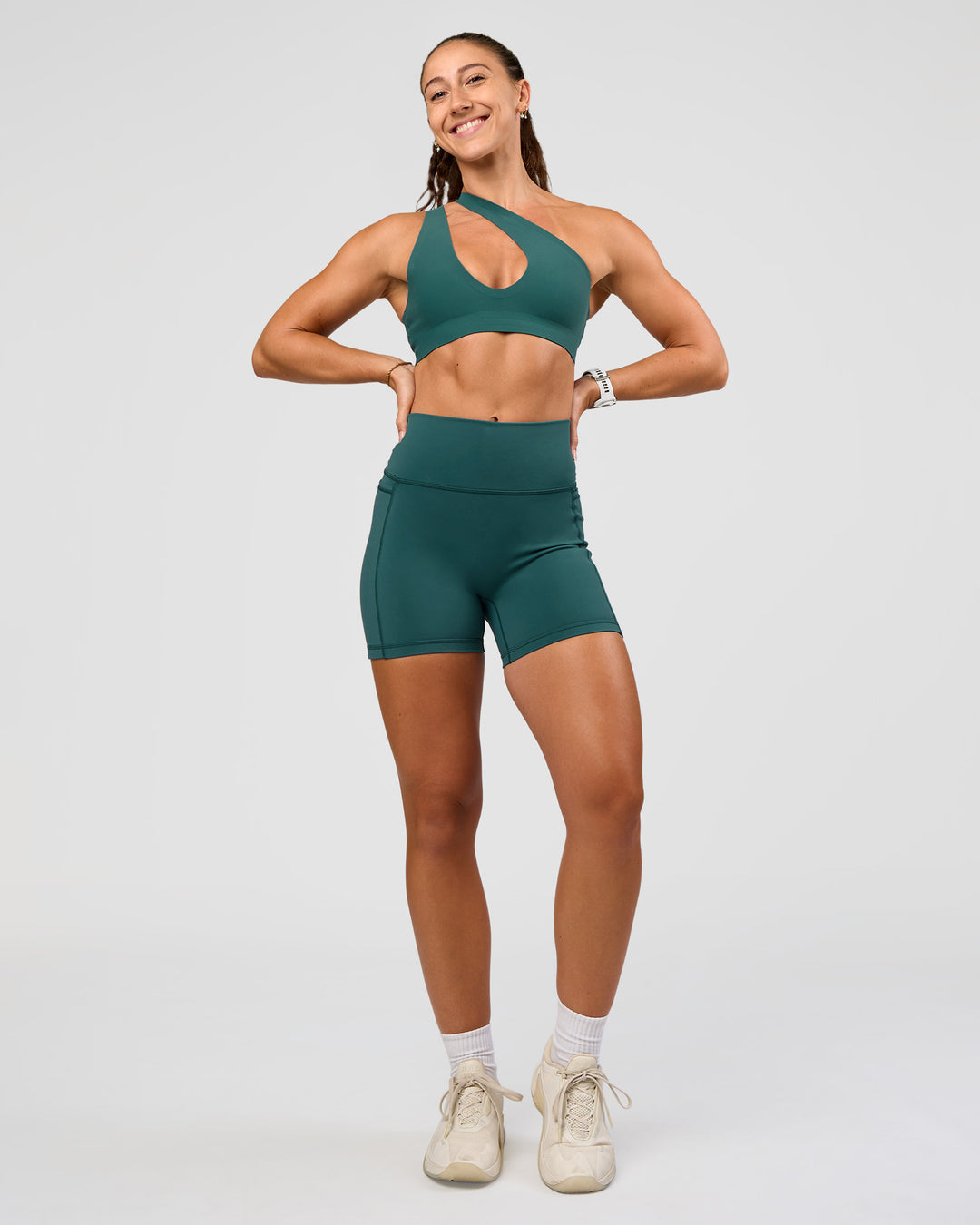 Woman wearing Fusion V-Contour Ultra High-Rise 4” Short Pockets - Transformative Teal | Model:Summer | Size:S