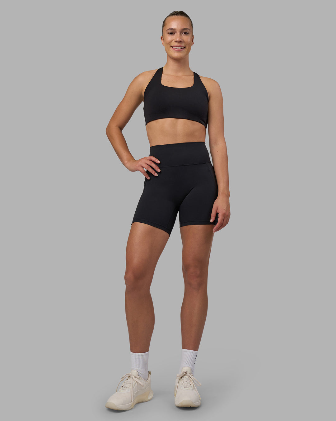 Woman wearing Fusion V-Contour Ultra High-Rise 6&quot; Short Pockets - Black | Model:Charlize | Size:S