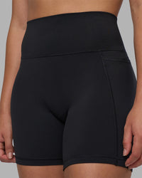 Woman wearing Fusion V-Contour Ultra High-Rise 6" Short Pockets - Black | Model:Charlize | Size:S