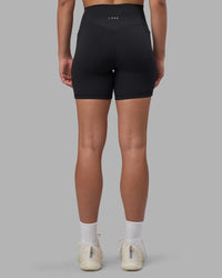 Woman wearing Fusion V-Contour Ultra High-Rise 6" Short Pockets - Black | Model:Charlize | Size:S