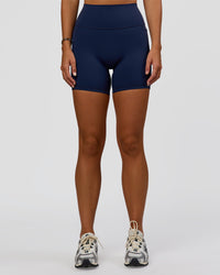 Woman wearing Fusion V-Contour Ultra High-Rise 6" Short Pockets - Future Navy 
| Model:Amity | Size:S