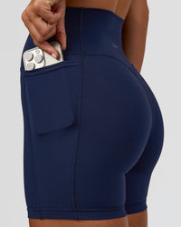 Woman wearing Fusion V-Contour Ultra High-Rise 6" Short Pockets - Future Navy 
| Model:Amity | Size:S