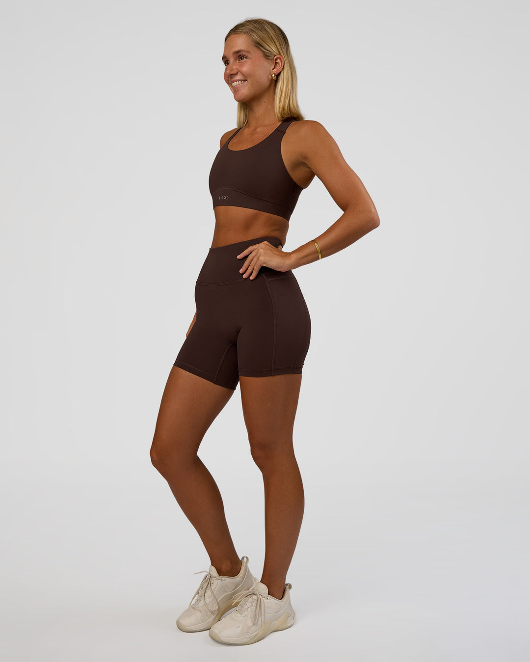 Woman wearing Fusion V-Contour Ultra High-Rise 6&quot; Short Pockets - Hot Chocolate | Model:Amity | Size:S