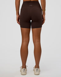 Woman wearing Fusion V-Contour Ultra High-Rise 6" Short Pockets - Hot Chocolate | Model:Amity | Size:S