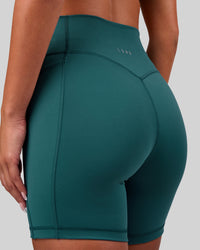 Woman wearing Fusion V-Contour Ultra High-Rise 6" Short Pockets - Transformative Teal | Model:Bianca | Size:S
