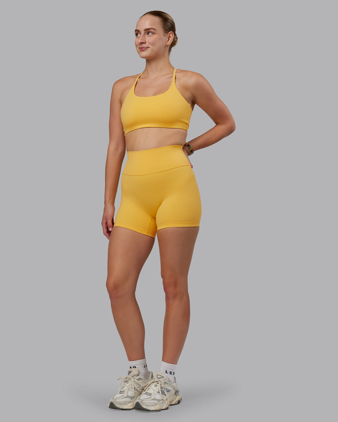 Woman wearing Fusion Ultra High-Rise 4&quot; Short - Banana Cream | Model:Lillie | Size:S