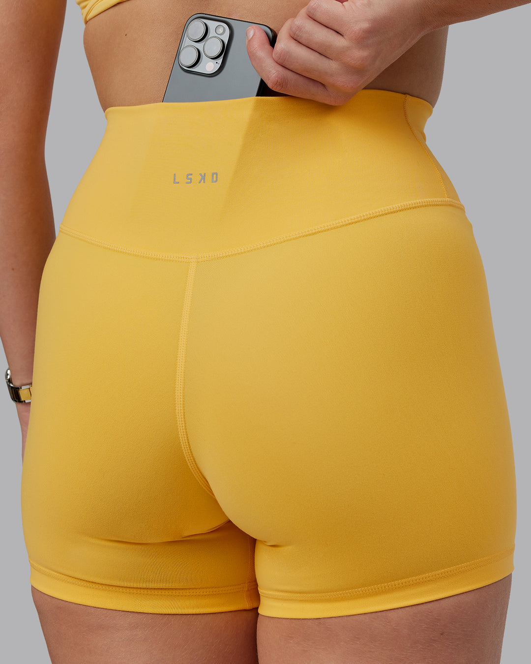 Woman wearing Fusion Ultra High-Rise 4&quot; Short - Banana Cream | Model:Lillie | Size:S