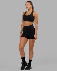 Woman wearing O.G. Fusion Ultra High-Rise 4" Short Pockets - Black | Model:Milly | Size:S