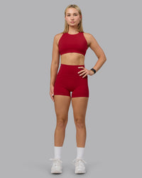 Woman wearing Fusion Ultra High-Rise 4" Short Pockets - Cherry Red | Model:Halle | Size:S