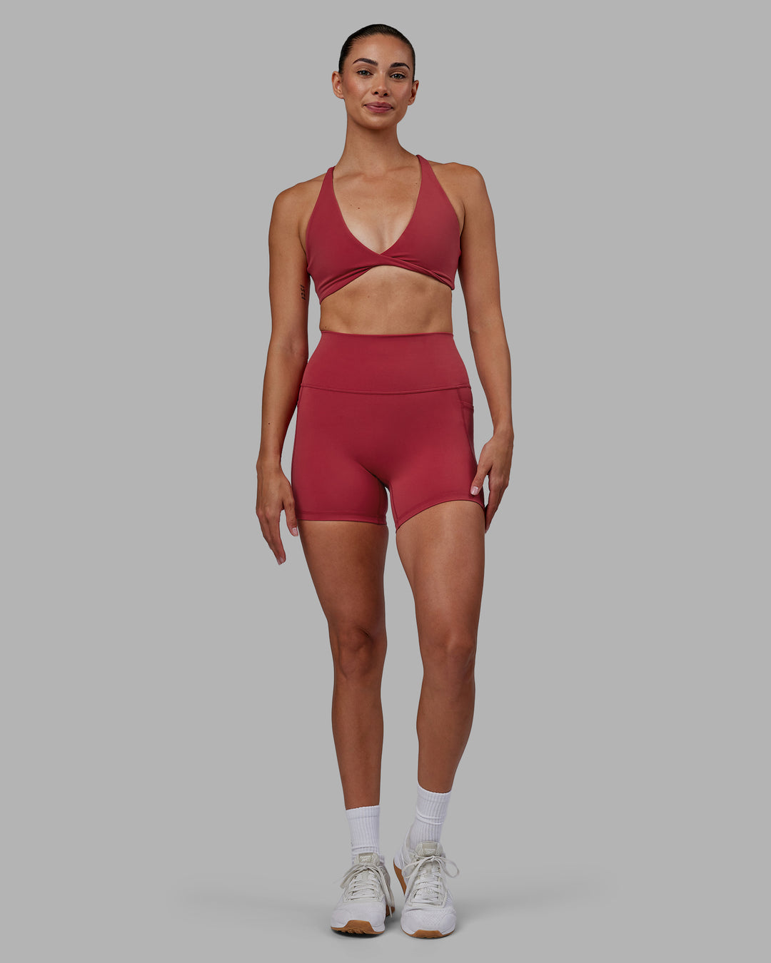 Woman wearing Fusion Ultra High-Rise 4&quot; Short Pockets - Claret | Model:Blaize | Size:S