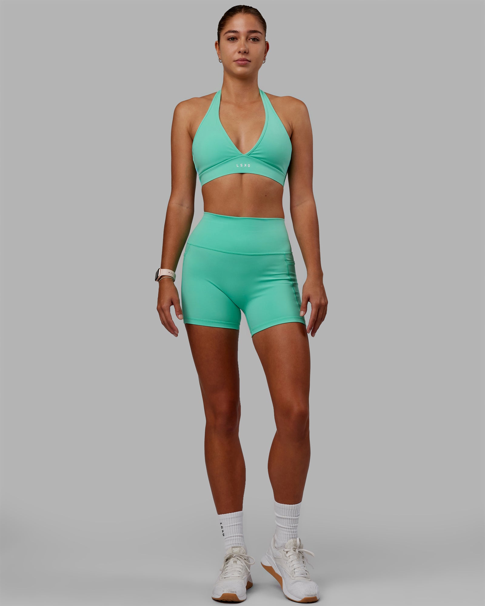 Woman wearing Fusion Ultra High-Rise 4" Short Pockets - Cockatoo | Model:Asia | Size:S