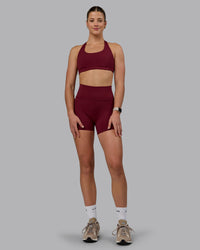 Woman wearing Fusion Ultra High-Rise 4" Short Pockets - Cordovan | Model:Chloe | Size:XS