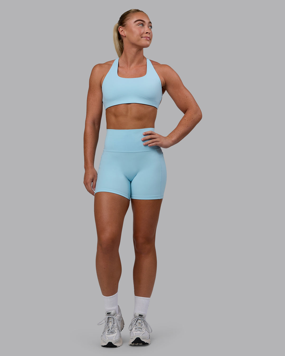 Woman wearing Fusion Ultra High-Rise 4&quot; Short Pockets - Glacial Blue | Model:Monique | Size:S