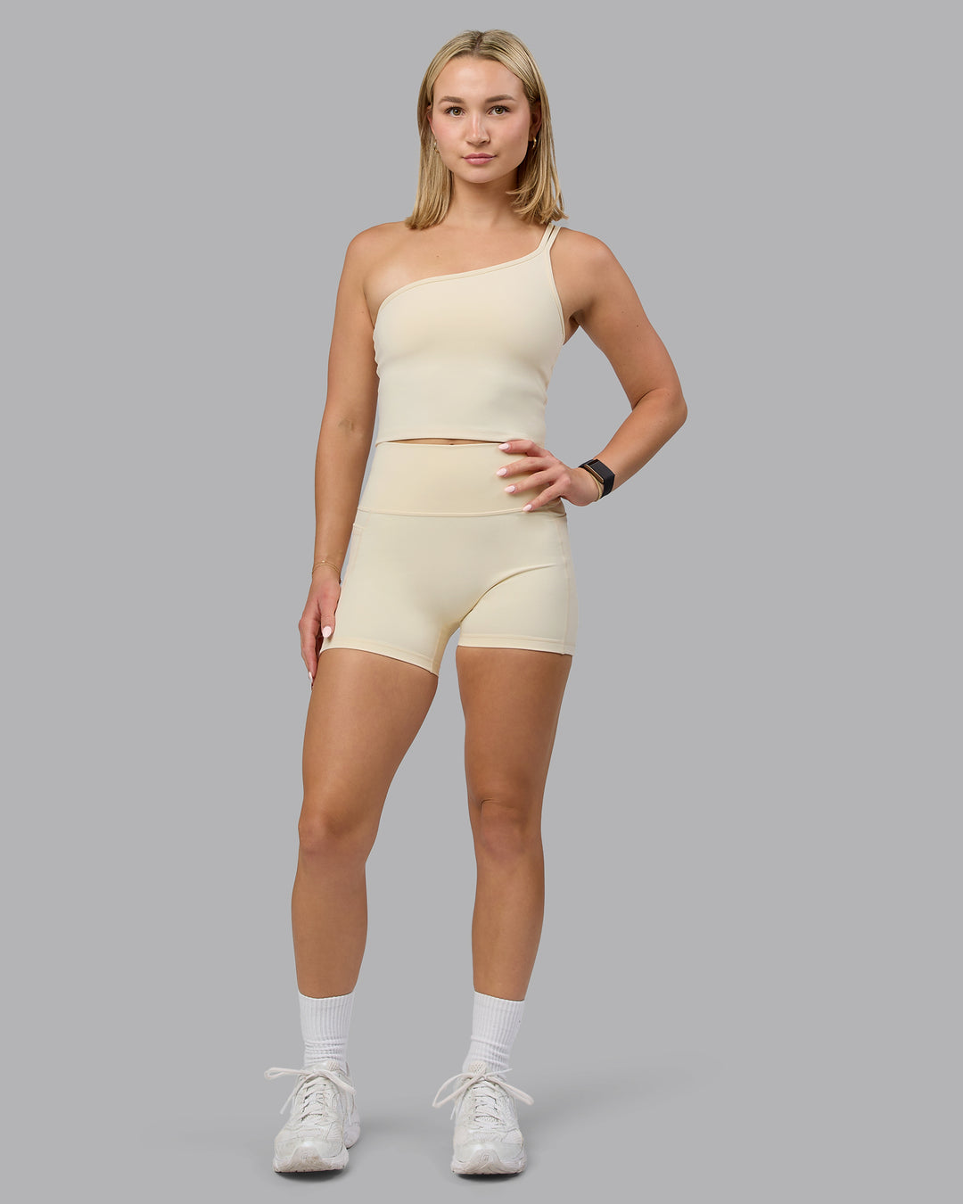 Woman wearing Fusion Ultra High-Rise 4&quot; Short Pockets - Ivory | Model:Halle | Size:S