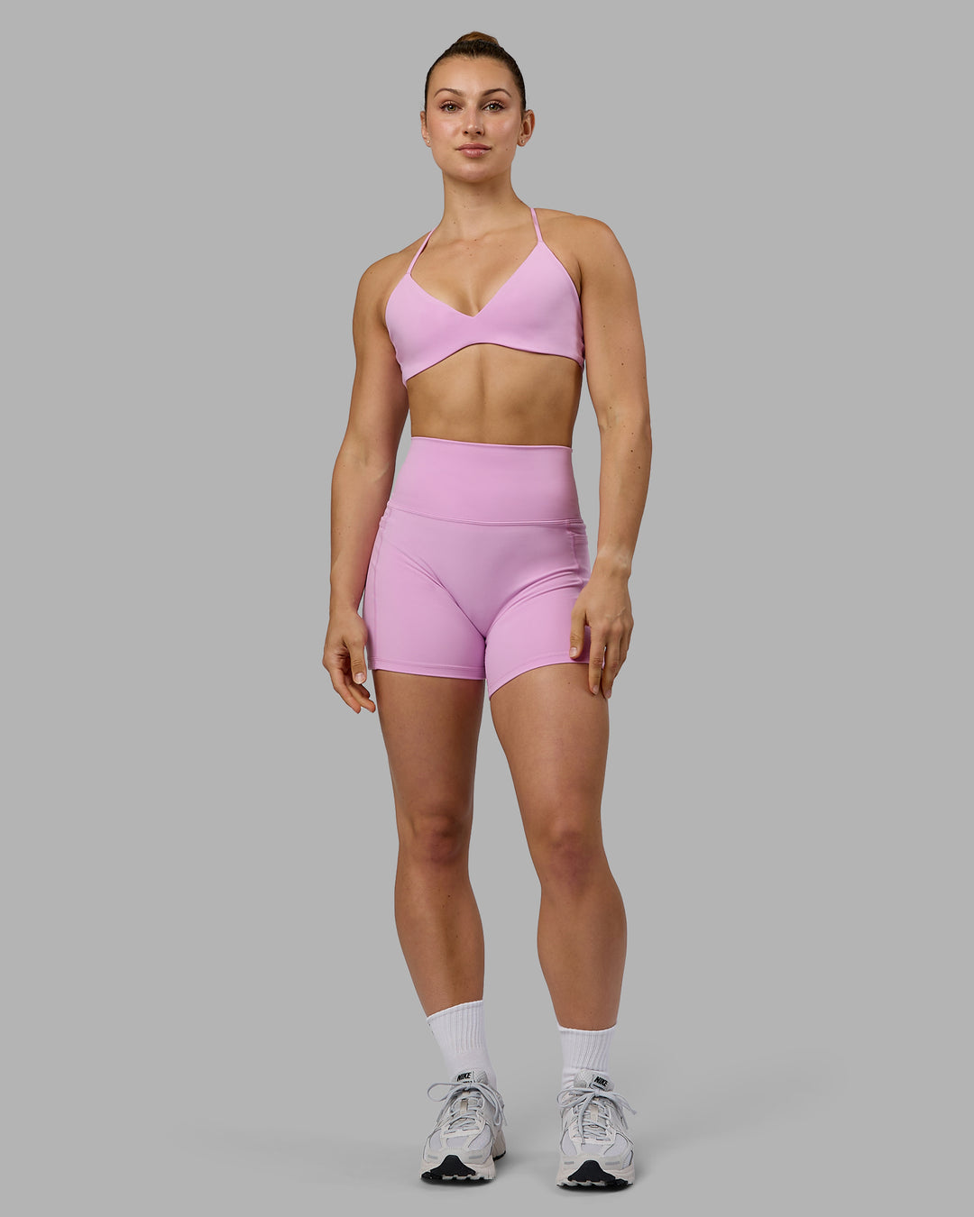Woman wearing Fusion Ultra High-Rise 4&quot; Short Pockets - Pastel Orchid | Model:Zoe | Size:S