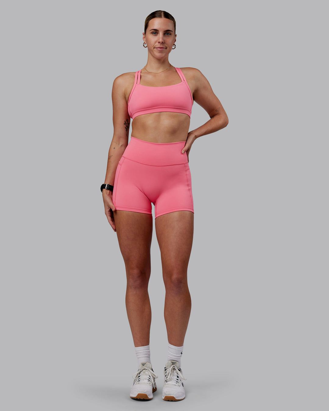 Woman wearing Fusion Ultra High-Rise 4" Short Pockets - Pink Lemonade | Model:Shae | Size:S