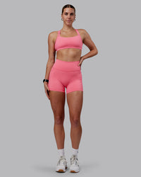 Woman wearing Fusion Ultra High-Rise 4" Short Pockets - Pink Lemonade | Model:Shae | Size:S