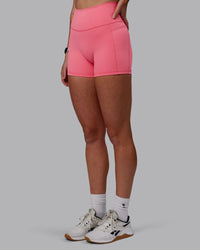 Woman wearing Fusion Ultra High-Rise 4" Short Pockets - Pink Lemonade | Model:Shae | Size:S
