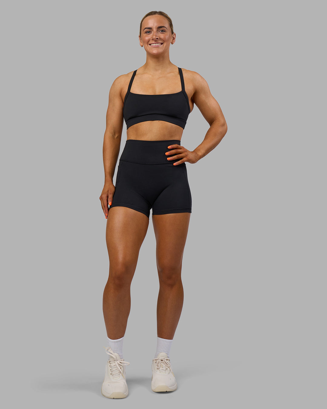 Woman wearing Fusion Ultra High-Rise 4&quot; Short Pockets - Black | Model:Georgia | Size:S