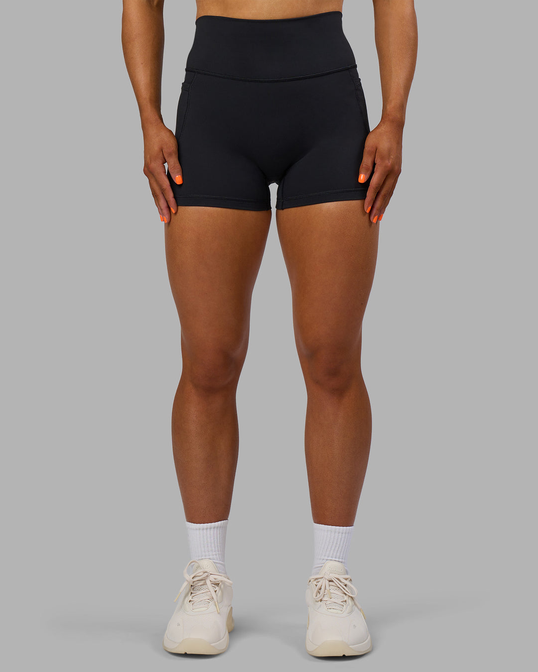 Woman wearing Fusion Ultra High-Rise 4&quot; Short Pockets - Black | Model:Georgia | Size:S