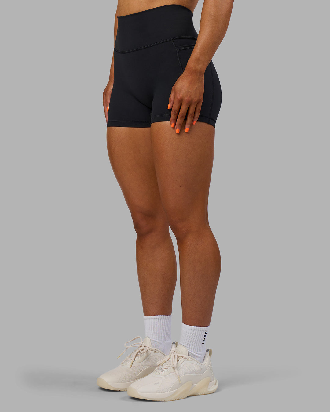 Woman wearing Fusion Ultra High-Rise 4&quot; Short Pockets - Black | Model:Georgia | Size:S