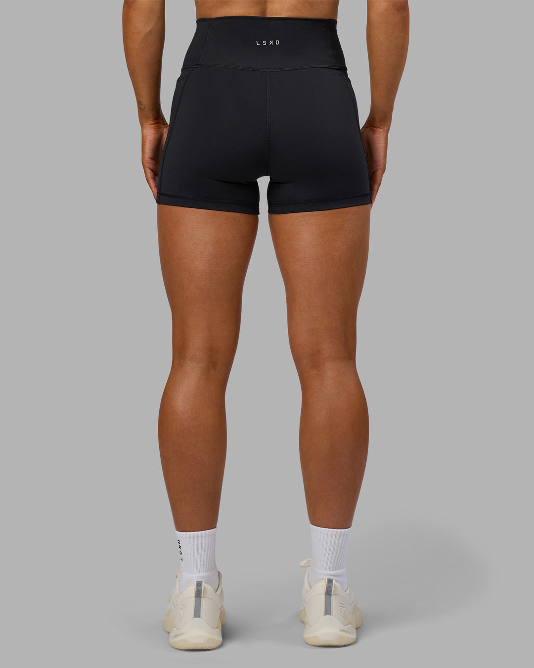 Woman wearing Fusion Ultra High-Rise 4&quot; Short Pockets - Black | Model:Georgia | Size:S