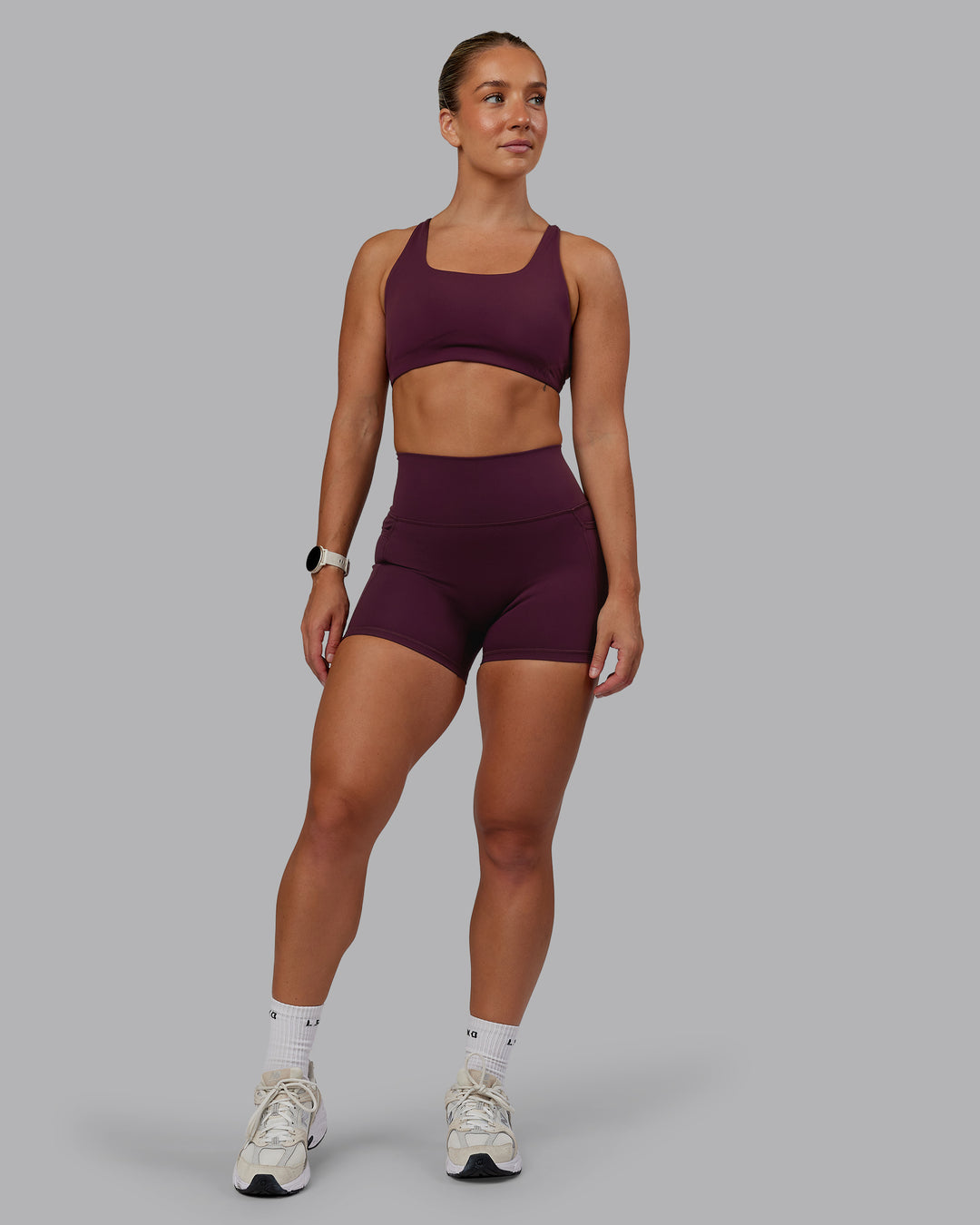 Woman wearing Fusion Ultra High-Rise 4&quot; Short Pockets - Cherry Lacquer | Model:Lyss | Size:S