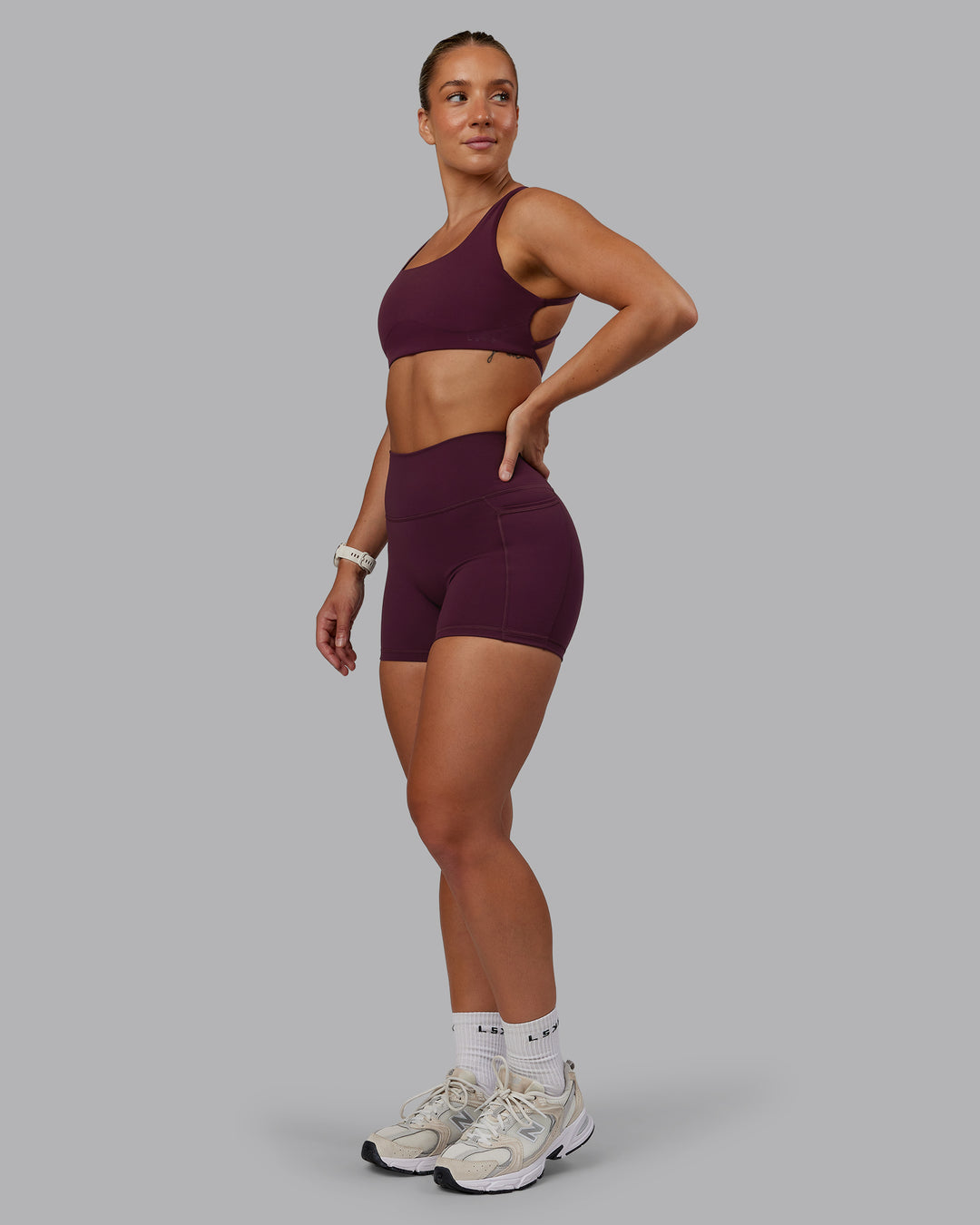 Woman wearing Fusion Ultra High-Rise 4&quot; Short Pockets - Cherry Lacquer | Model:Lyss | Size:S