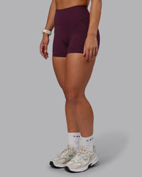 Woman wearing Fusion Ultra High-Rise 4" Short Pockets - Cherry Lacquer | Set:true | Angle:side | Model:Lyss | Size:S