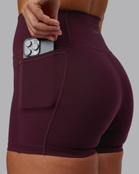 Woman wearing Fusion Ultra High-Rise 4" Short Pockets - Cherry Lacquer | Set:true | Angle:closeup | Model:Lyss | Size:S