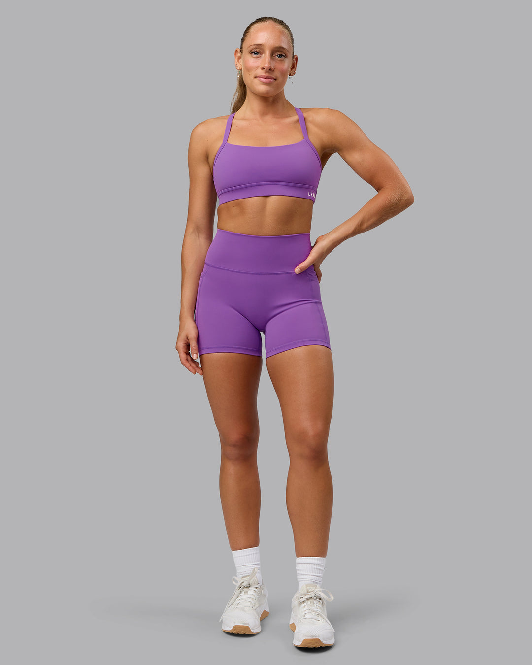 Woman wearing Fusion Ultra High-Rise 4&quot; Short Pockets - Purple Fizz | Model:Shalem | Size:S