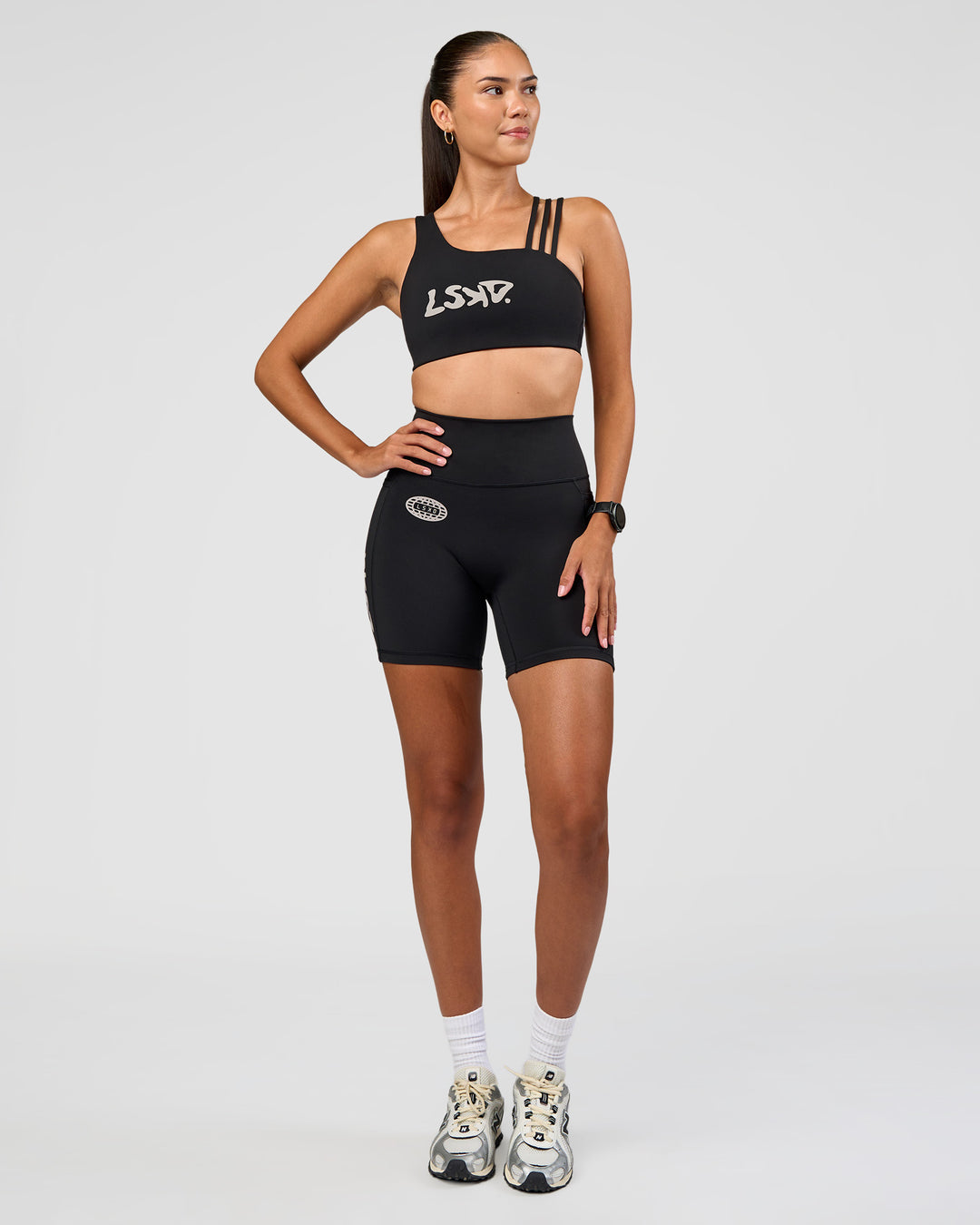 Woman wearing Galvanise Hype Graphic Sports Bra 2.0 - Black-Alloy | Model:Rhiley | Size:S