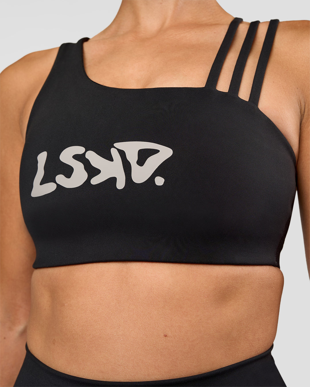 Woman wearing Galvanise Hype Graphic Sports Bra 2.0 - Black-Alloy | Model:Rhiley | Size:S