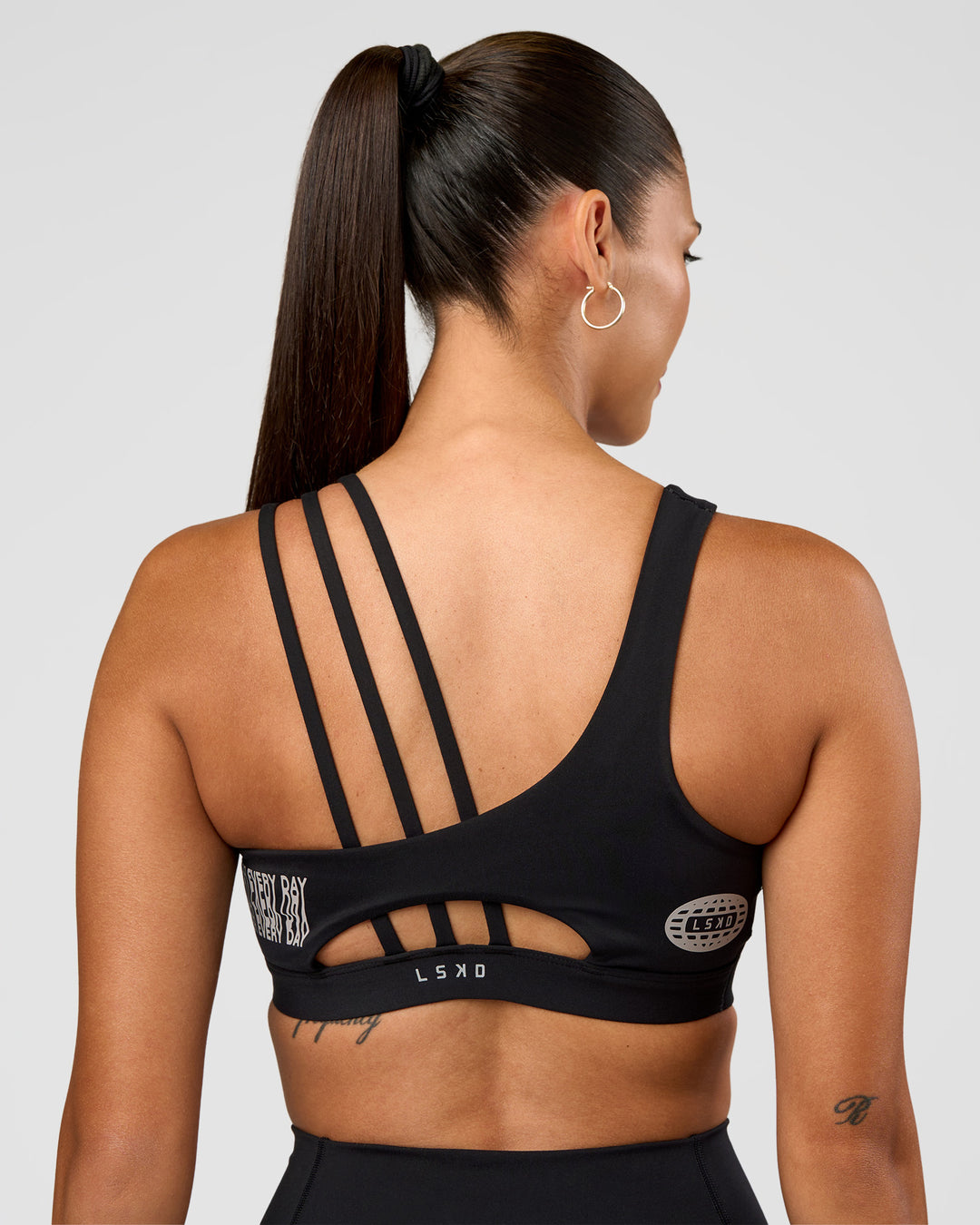 Woman wearing Galvanise Hype Graphic Sports Bra 2.0 - Black-Alloy | Model:Rhiley | Size:S