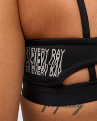 Woman wearing Galvanise Hype Graphic Sports Bra 2.0 - Black-Alloy | Model:Rhiley | Size:S