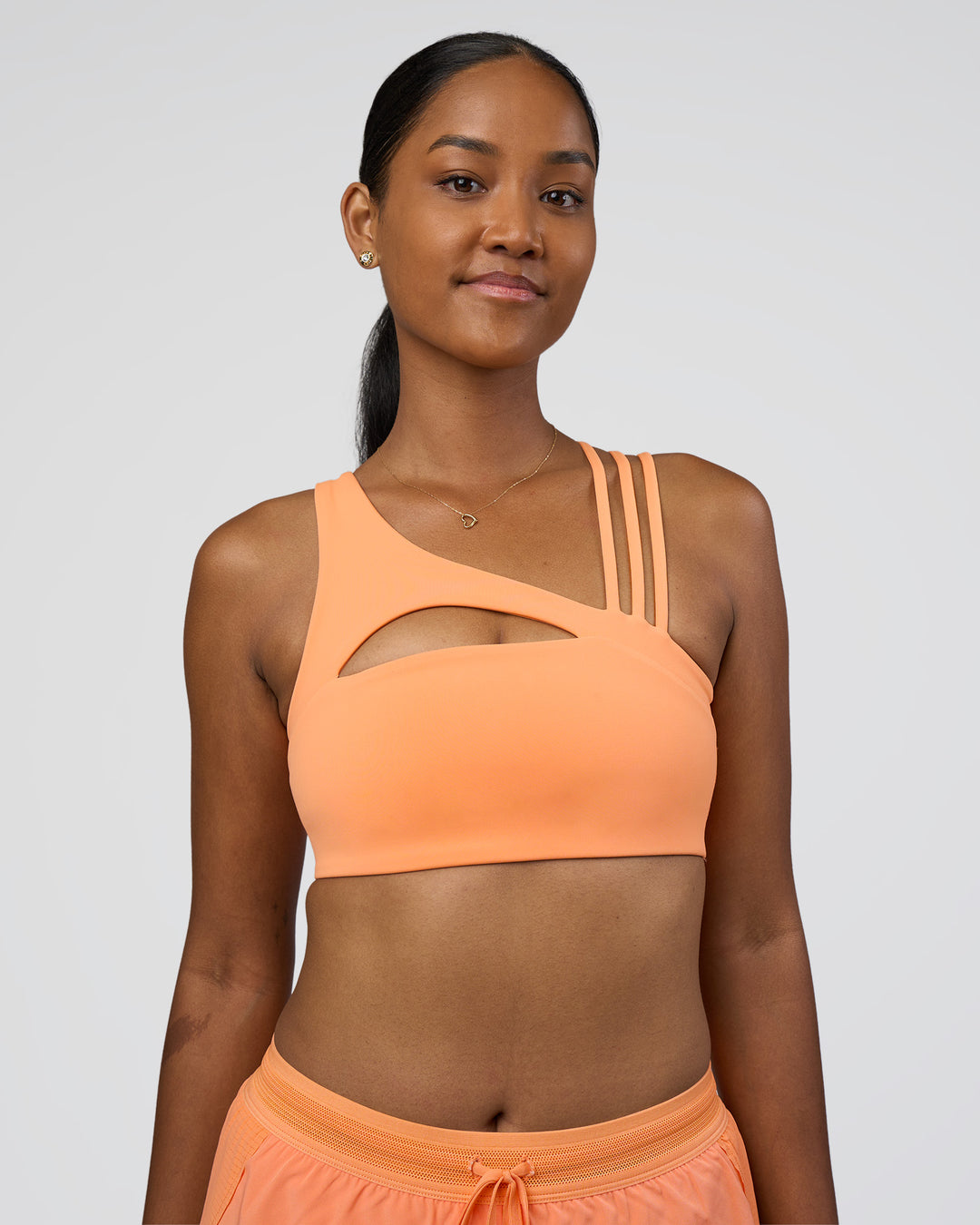 Woman wearing Galvanise Splice Sports Bra - Cantaloupe | Model:Rica | Size:S