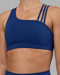 Woman wearing Galvanise Sports Bra 2.0 - Midnight Blue | Set:true | Angle:closeup | Model:Charlize | Size:S